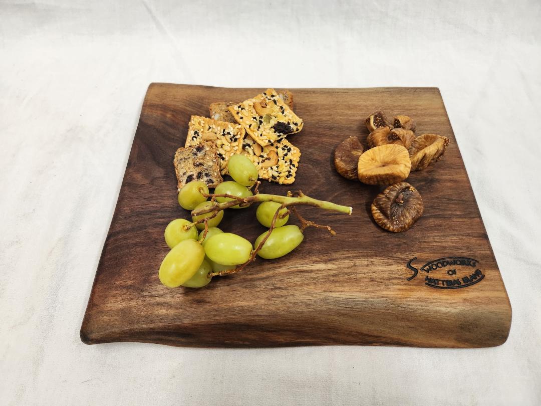 Live edge black walnut charcuterie board. Medium sized. Great for movie night.